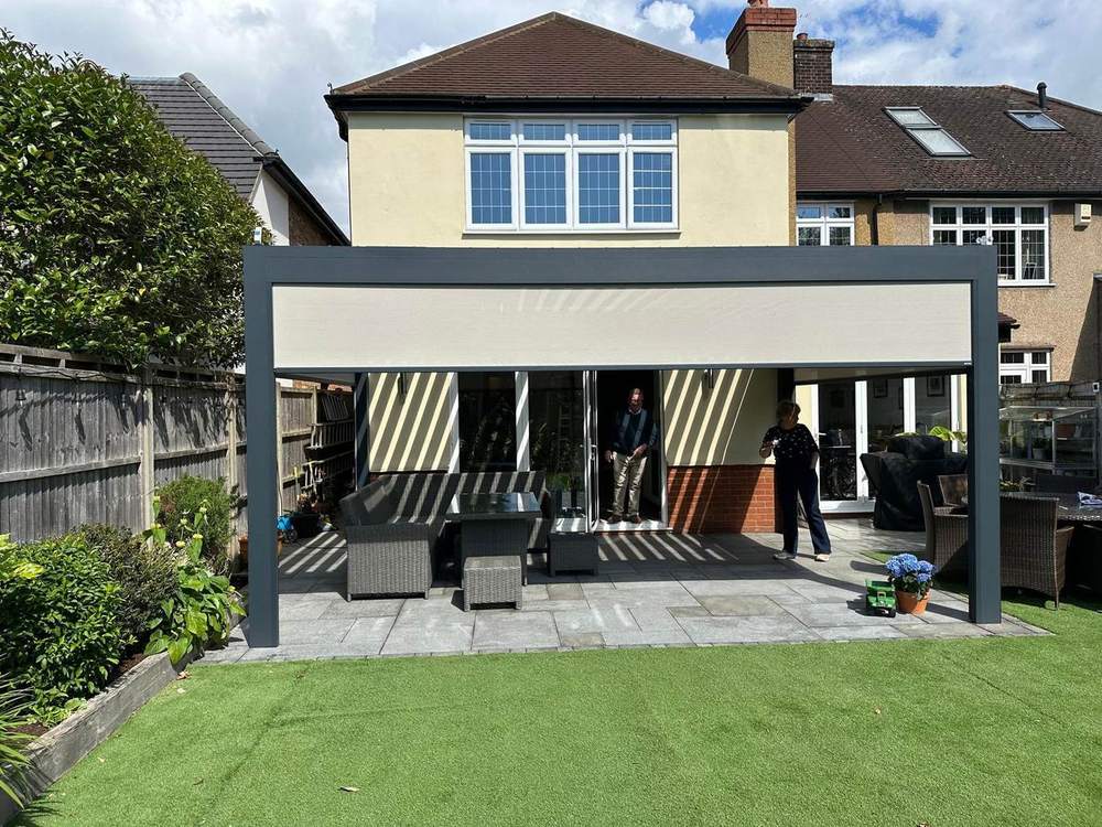 Fabric roof aluminium pergola shading a garden dining terrace