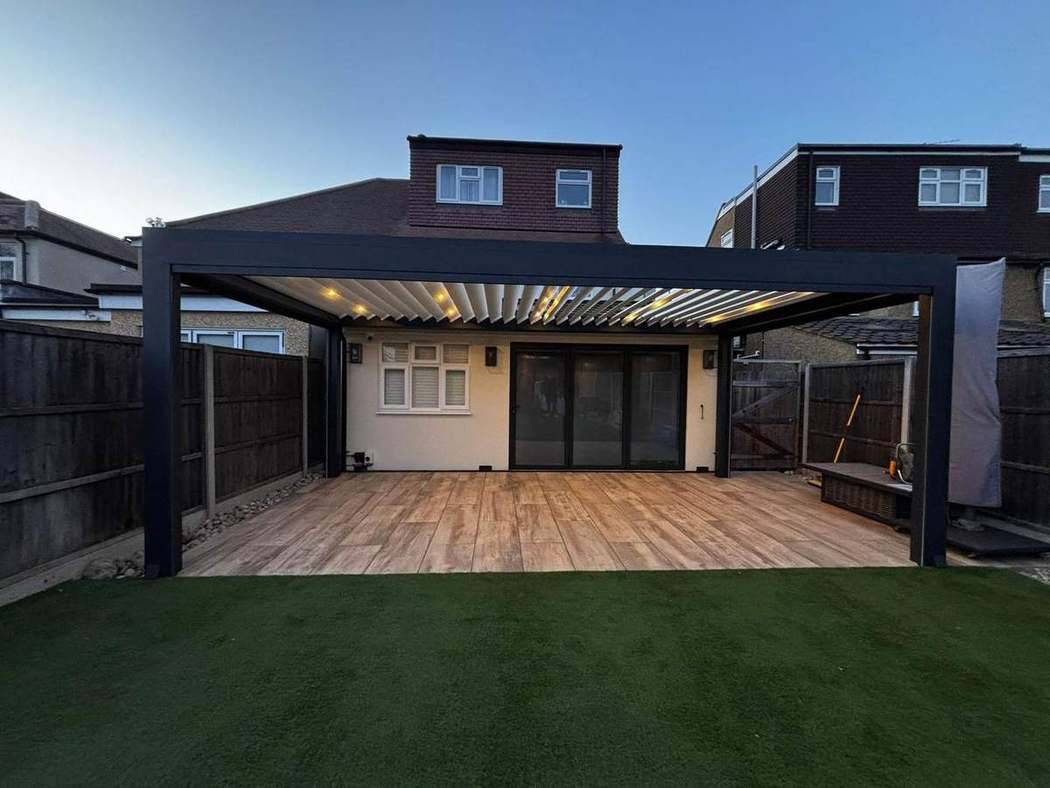 Large aluminium pergola over a decked and paved terrace, installed by Harmony View